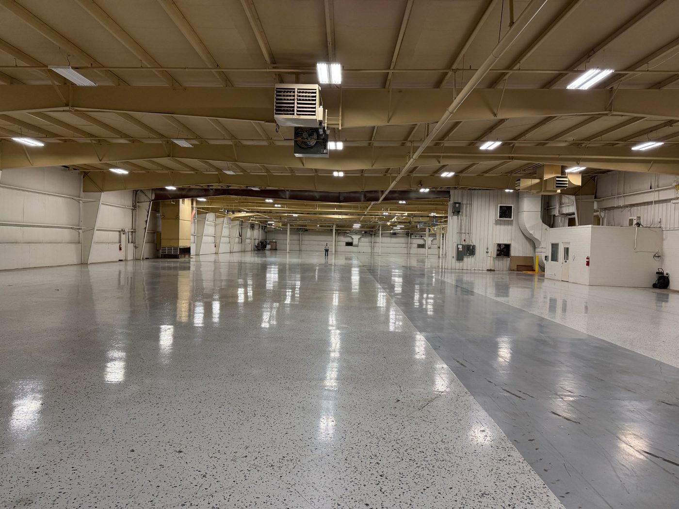 Clean indoor storage facility with epoxy floors and overhead lighting